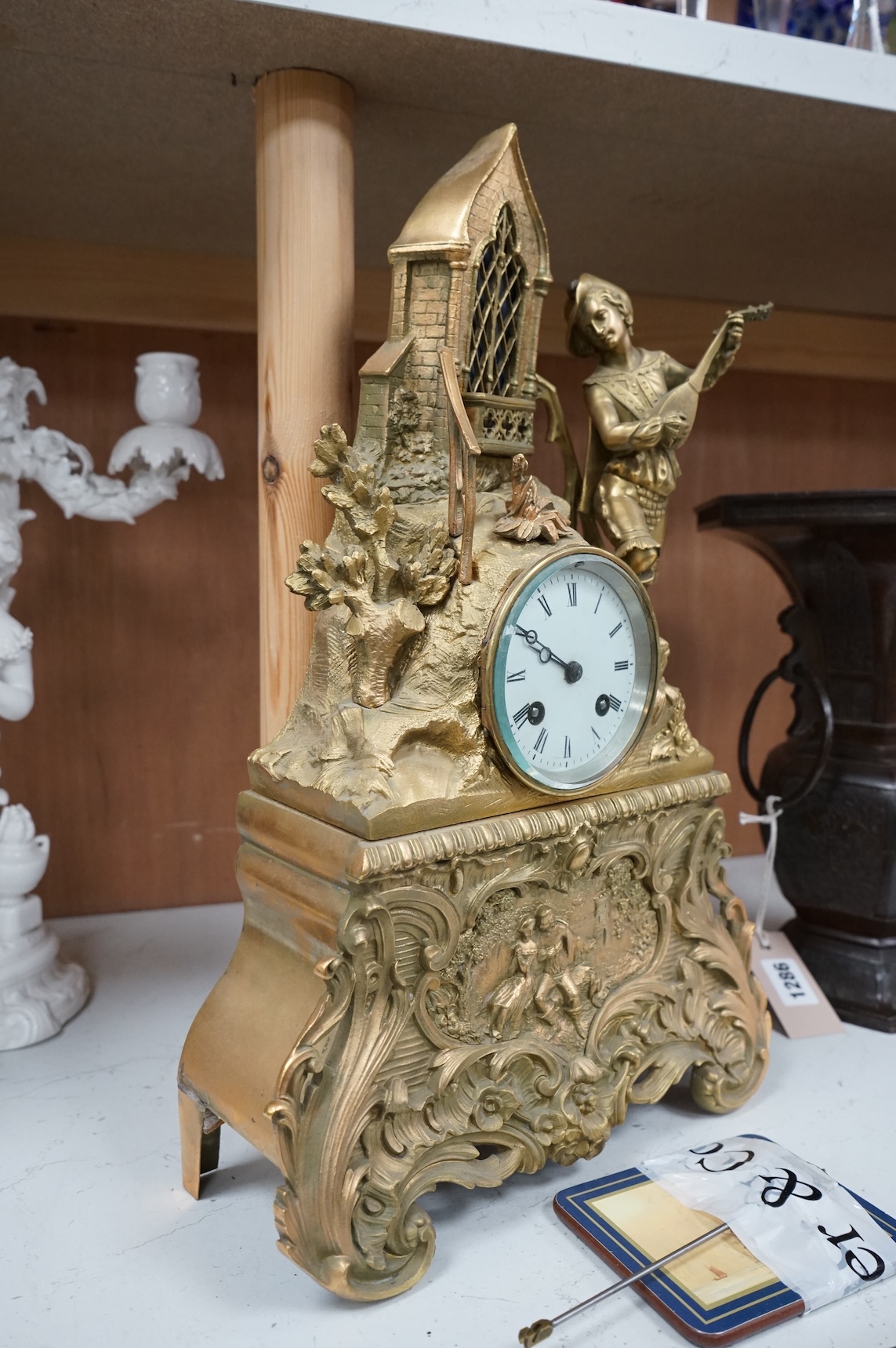 A late 19th century French gilt bronze mantel clock, with figural surmount, 42.5cm high.